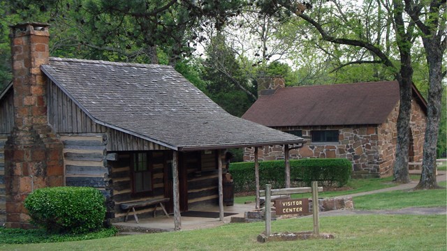 A wooden cabin with a small covered front porch.